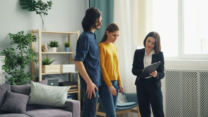 a man and a woman standing in a living room